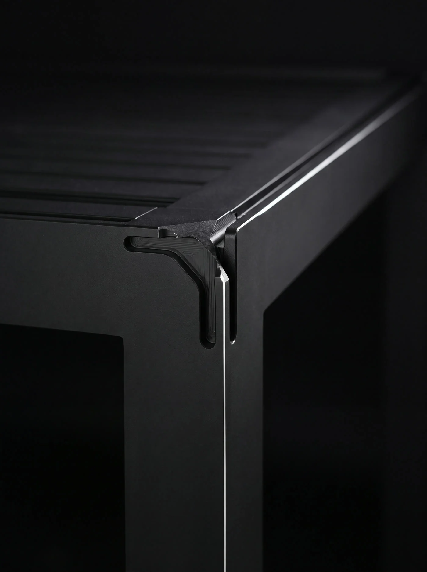 Close view of a black aluminum pergola corner joint.