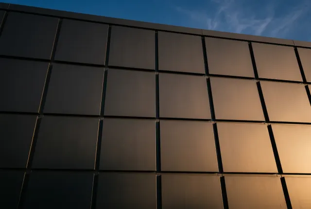 Dark aluminium composite panel cladding with shadow-gap joints