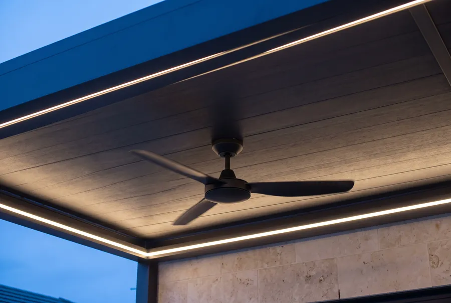 Ceiling fan under a solid pergola roof