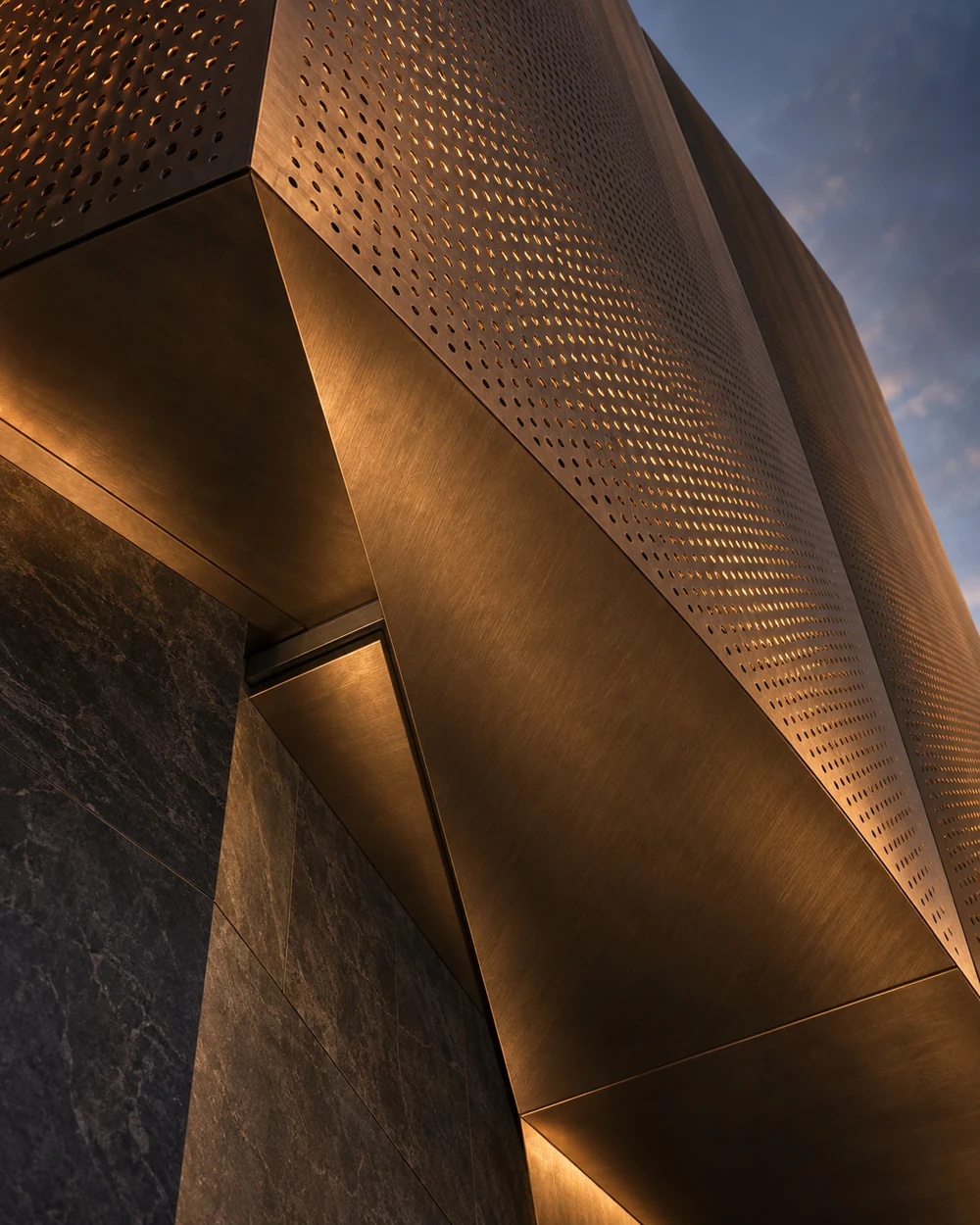 Architectural concept looking upward at a folded bronze facade with warm light passing through fine perforations against a blue-grey twilight sky